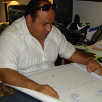 Sugar Land home remodeling and home construction expert George Villarreal reviewing plans.